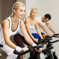 Group of people doing exercise on a bike in a gym