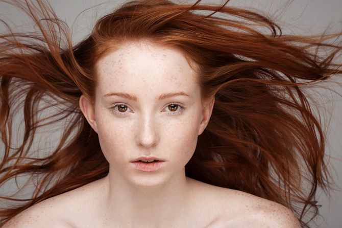 A young woman with flowing red hair