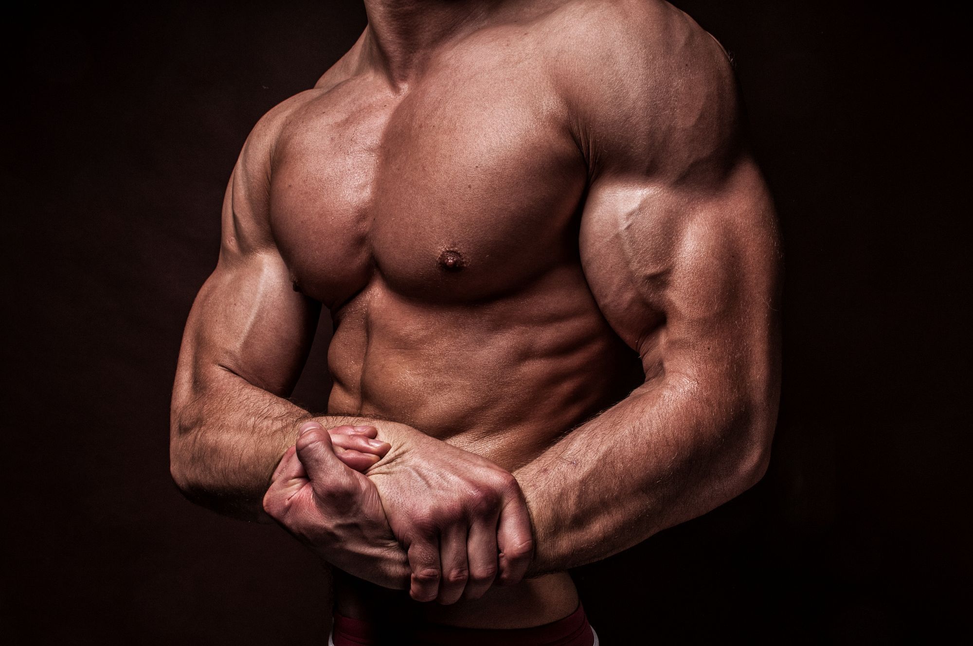 Тело резко. Мышцы. Мускулистый человек. Мышцы мужчины. Здоровое мужское тело.